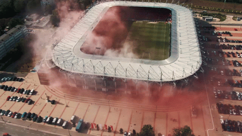 An Aerial View Of A Soccer Stadium With Smoke Coming Out Of It GIF