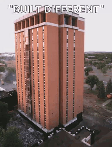 An Aerial View Of A Tall Building With The Words " Built Different " Below It GIF