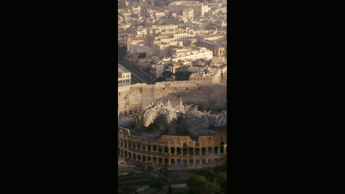 An Aerial View Of The Colosseum In Rome With A City In The Background GIF
