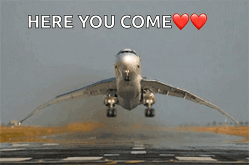 An Airplane Is Taking Off From A Runway And The Words Here You Come Are Above It GIF
