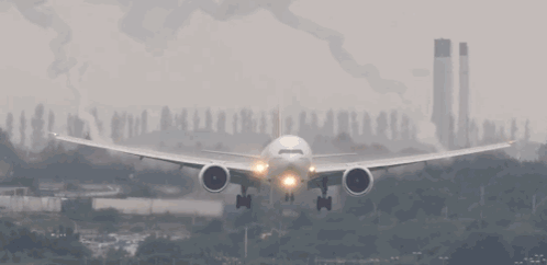 An Airplane Is Taking Off From A Runway With Smoke Coming Out Of Its Wings GIF