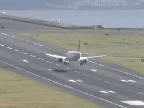 An Airplane Is Taking Off From A Runway With The Number 8 On The Right Side GIF