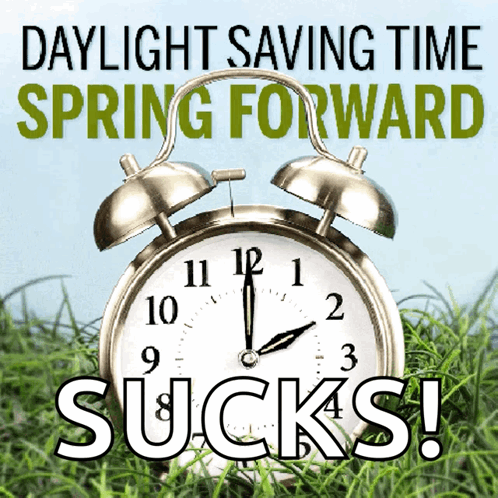 An Alarm Clock Is Sitting In The Grass With The Words Daylight Saving Time Spring Forward Sucks GIF