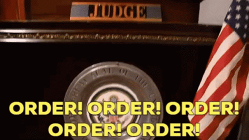 An American Flag Is In Front Of A Judge 'S Desk With The Words Order Order Order Order GIF