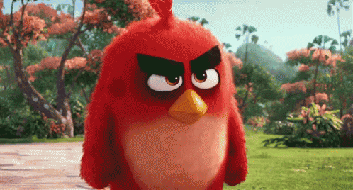 An Angry Bird From The Movie Angry Birds Is Standing In The Grass GIF