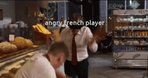 An Angry French Player Is Standing In Front Of A Display Case Of Bread GIF