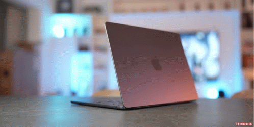 An Apple Laptop Is Open And Sitting On A Table With Think Files Written On The Bottom GIF