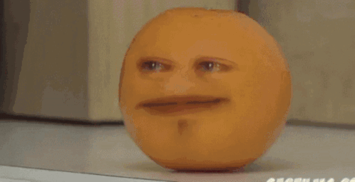 An Apple With A Face On It Is Sitting On A Table GIF