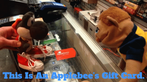 An Applebee 'S Gift Card Is On A Glass Display Case GIF