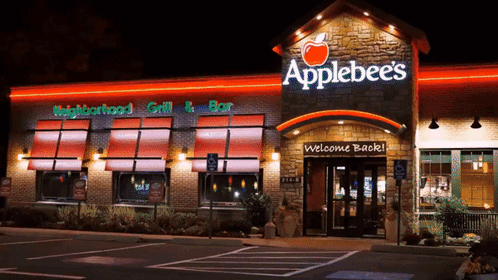 An Applebee 'S Restaurant With A Welcome Back Sign In Front Of It GIF