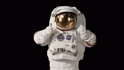 An Astronaut Is Giving A Thumbs Up Sign While Wearing A Nasa Space Suit . GIF