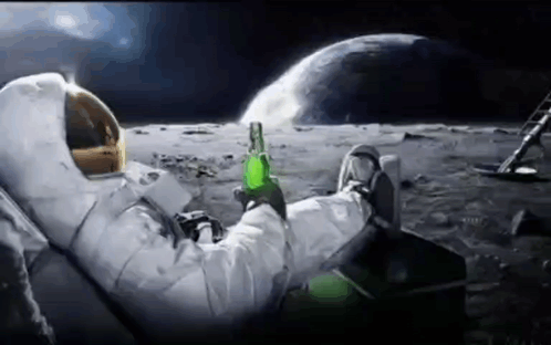 An Astronaut Is Sitting On The Moon Drinking A Beer . GIF