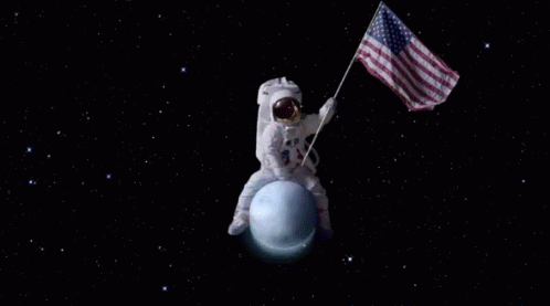 An Astronaut On The Moon With An American Flag Behind Him GIF
