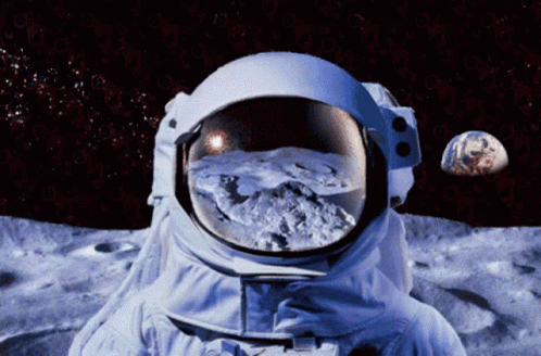 An Astronaut Stands On The Moon Looking At The Earth GIF
