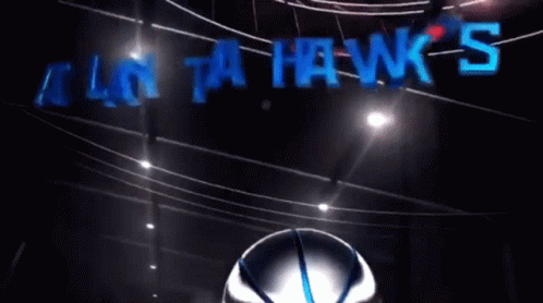 An Atlanta Hawks Logo With A Bird Holding A Basketball In Its Beak GIF