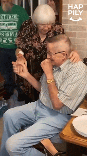 An Elderly Couple Holding Hands With A Woman Wearing A Green Shirt That Says Get There GIF