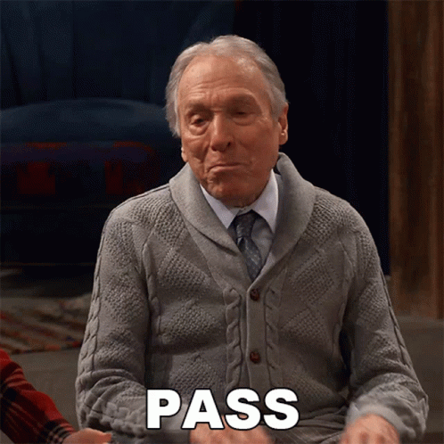 An Elderly Man In A Grey Sweater And Tie Is Saying Pass GIF