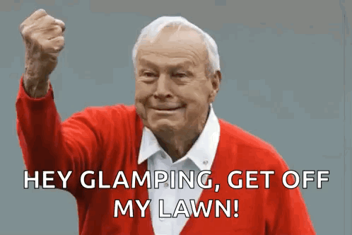 An Elderly Man In A Red Sweater Is Making A Funny Face With His Fist In The Air . GIF