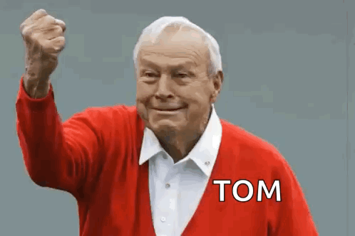 An Elderly Man In A Red Sweater With The Word Tom On It GIF