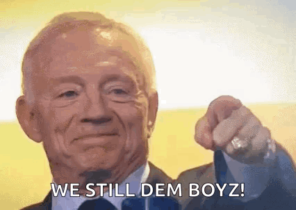 An Elderly Man In A Suit And Tie Is Pointing At The Camera And Saying `` We Still Dem Boyz '' . GIF