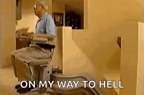 an elderly man is sitting in a wheelchair with the words `` on my way to hell '' written on the bottom .