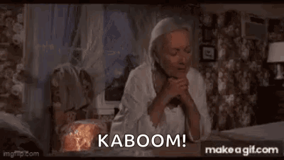 An Elderly Man Is Sitting In Front Of A Window With His Hands Folded And Says Kaboom ! GIF