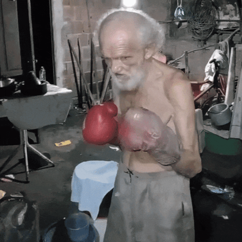 An Elderly Man Wearing Red Boxing Gloves With The Letter H On The Gloves GIF