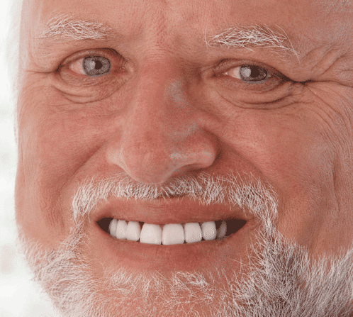 An Elderly Man With A Beard And White Teeth Smiles GIF