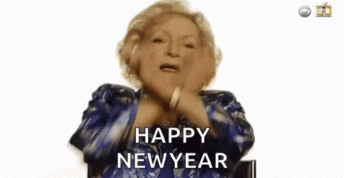 An Elderly Woman In A Blue Jacket Is Saying `` Happy New Year '' . GIF
