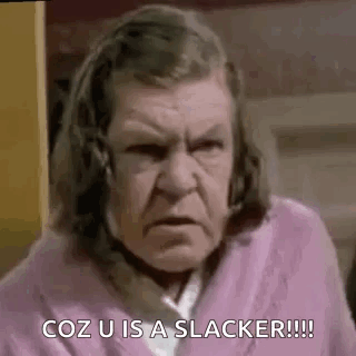 An Elderly Woman In A Pink Robe Is Making A Funny Face And Saying `` Coz U Is A Slacker ! '' GIF