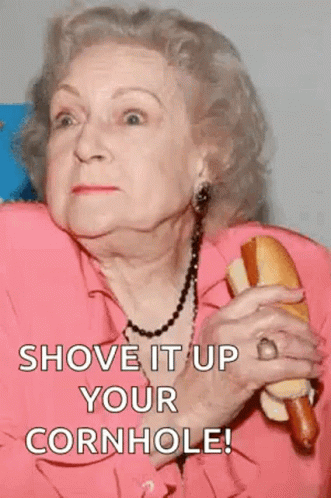 An Elderly Woman Is Holding A Hot Dog In Her Hand And Says Shove It Up Your Cornhole ! GIF