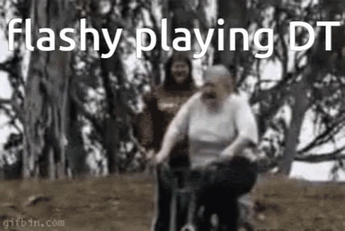 An Elderly Woman Is Riding A Bicycle In A Park While A Man Watches . GIF