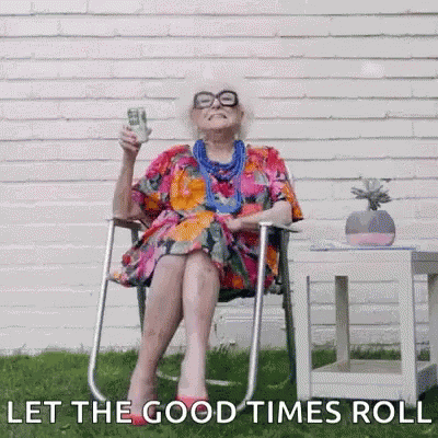 An Elderly Woman Is Sitting In A Chair Holding A Dollar Bill And A Glass Of Beer . GIF