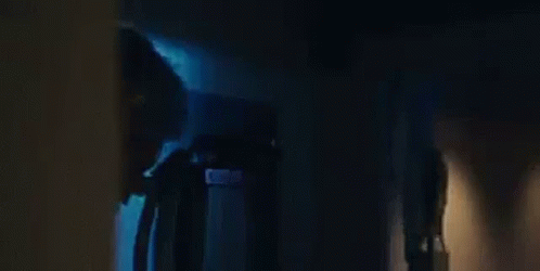 An Elderly Woman Is Sitting In A Chair With The Words `` The Temptations '' Written Above Her . GIF