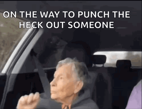 An Elderly Woman Is Sitting In The Driver 'S Seat Of A Car And Yelling . GIF