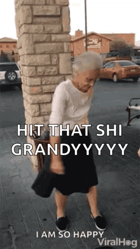 An Elderly Woman Is Standing In Front Of A Brick Wall Holding A Purse . GIF