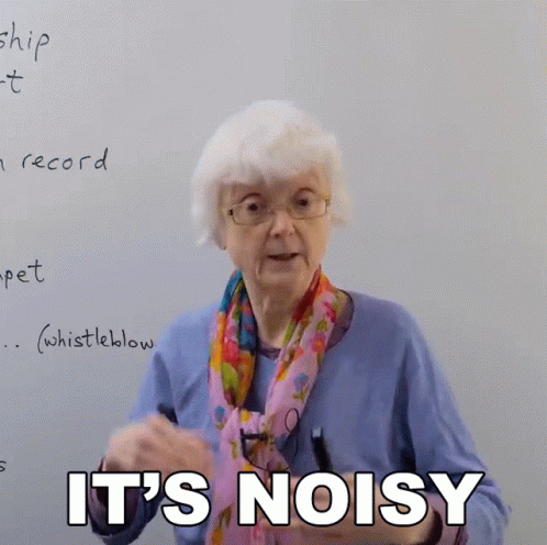 An Elderly Woman Says " It 'S Noisy " In Front Of A Whiteboard GIF