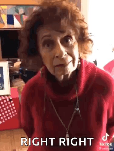 An Elderly Woman Wearing A Red Sweater Is Making A Funny Face And Says Right Right . GIF