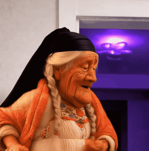 An Elderly Woman Wearing An Orange Robe And A Black Headband GIF
