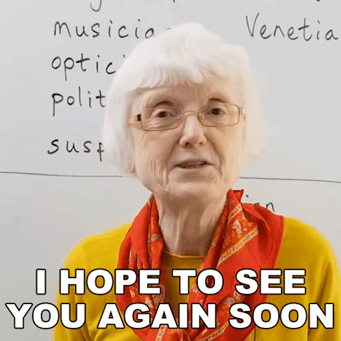 An Elderly Woman Wearing Glasses And A Scarf Says I Hope To See You Again Soon GIF