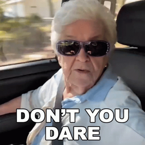 An Elderly Woman Wearing Sunglasses Says " Do N't You Dare " While Driving A Car GIF