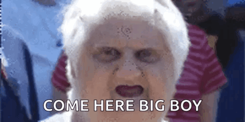 an elderly woman with a scary face and the words come here big boy written on her face .