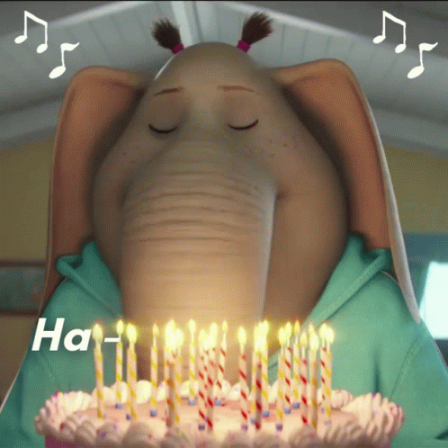 An Elephant Blowing Out Candles On A Birthday Cake That Says Ha GIF