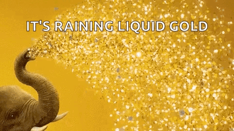 An Elephant Is Spraying Gold Confetti With Its Trunk . GIF