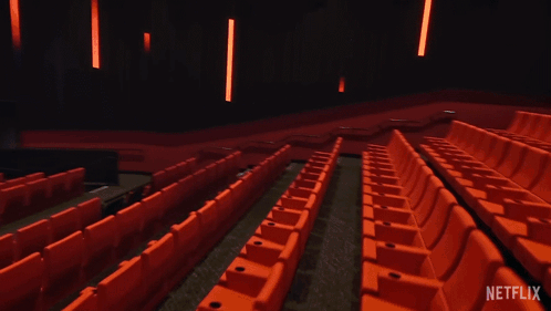 An Empty Movie Theater With A Netflix Logo On The Screen GIF