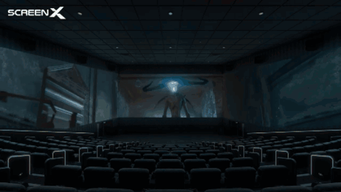 An Empty Movie Theater With A Screen X Logo Behind It GIF