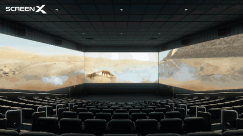 An Empty Movie Theater With A Screen X Logo In The Corner GIF