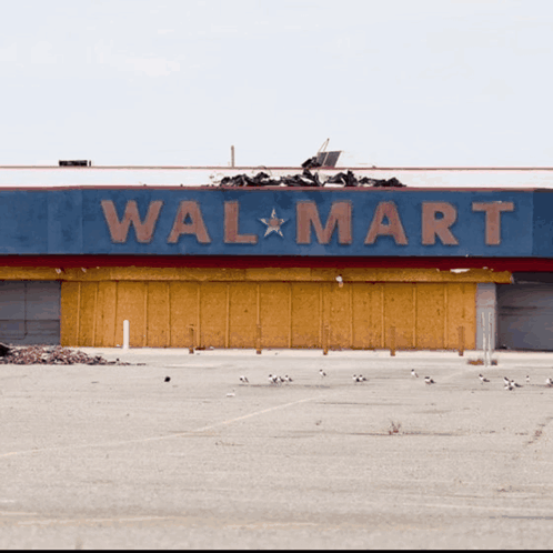 An Empty Parking Lot In Front Of An Empty Walmart GIF