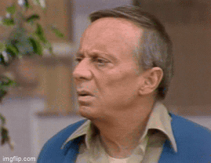An Older Man In A Blue Jacket Is Making A Funny Face . GIF
