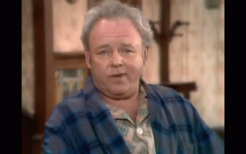 Older Man In Blue Plaid Robe Sitting GIF